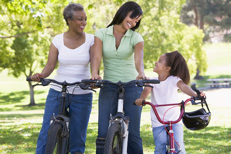 Employee Benefits - Loving Grandmother, Mother and Daughter Taking a Break From Riding Their Bikes at a Park